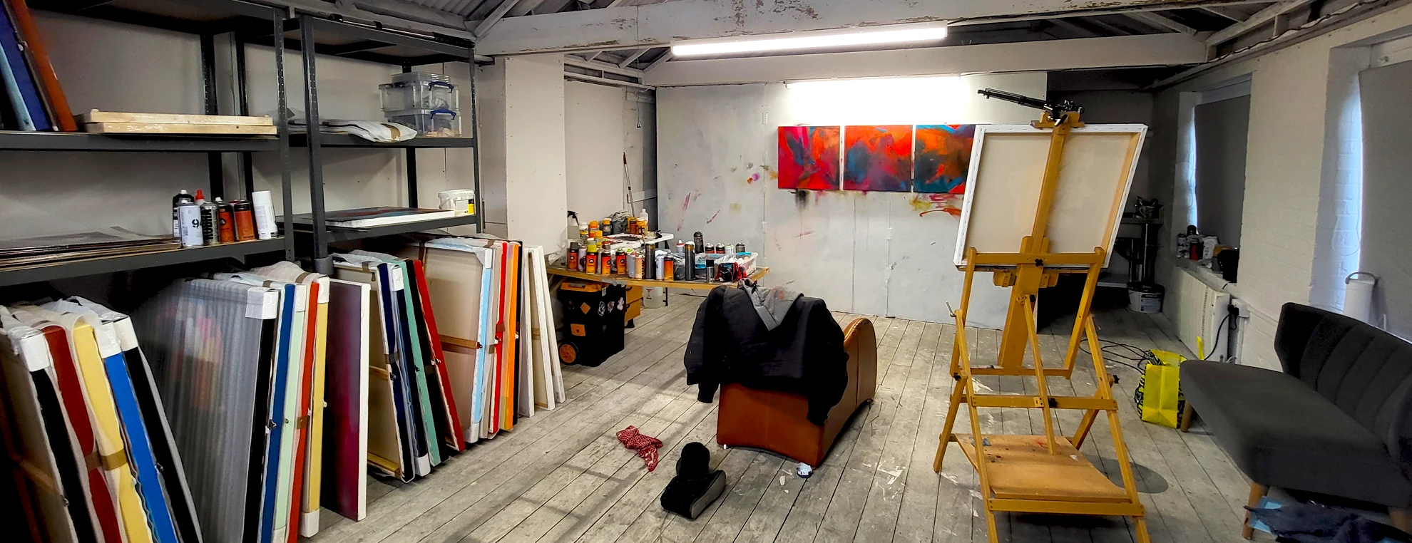 Artist studio of Paul Kneen showing abstract paintings, easel and workspace with materials and canvases