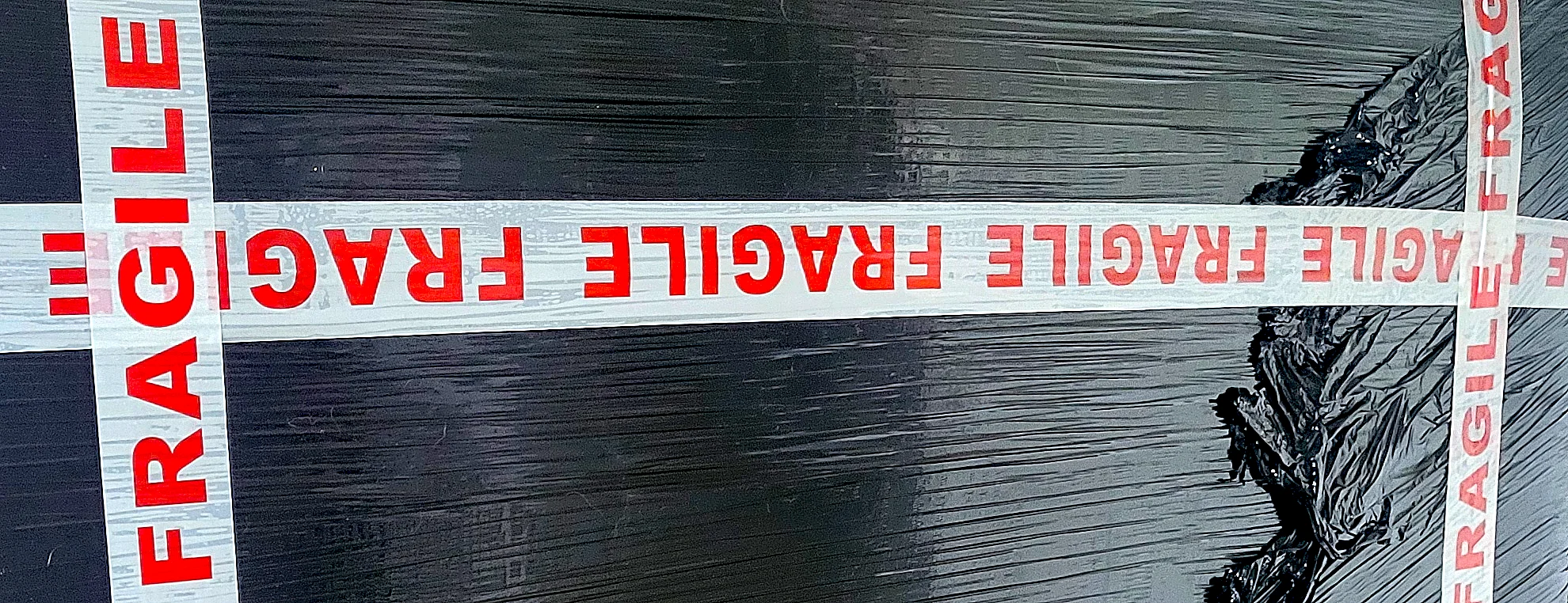 Packaged original painting wrapped for shipment with fragile tape